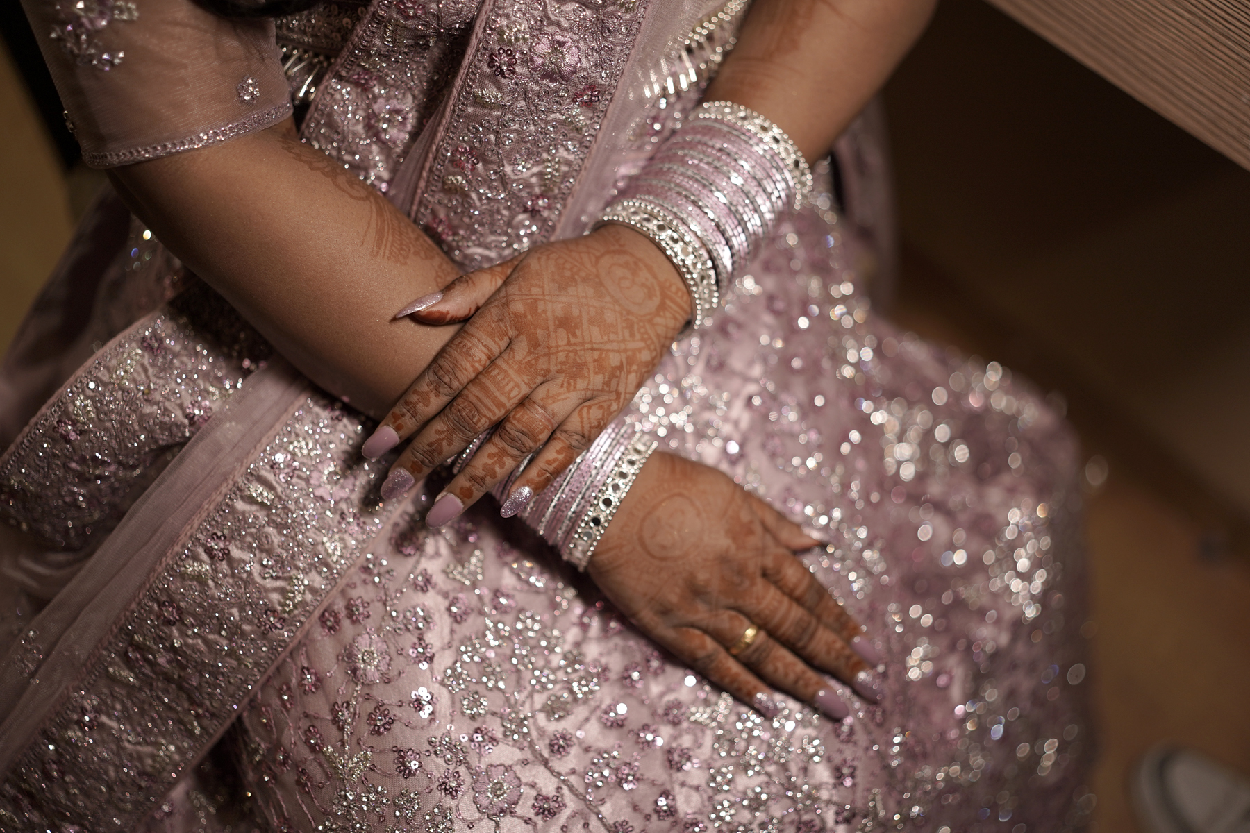 Close-up of mehendi hands and wedding bangles